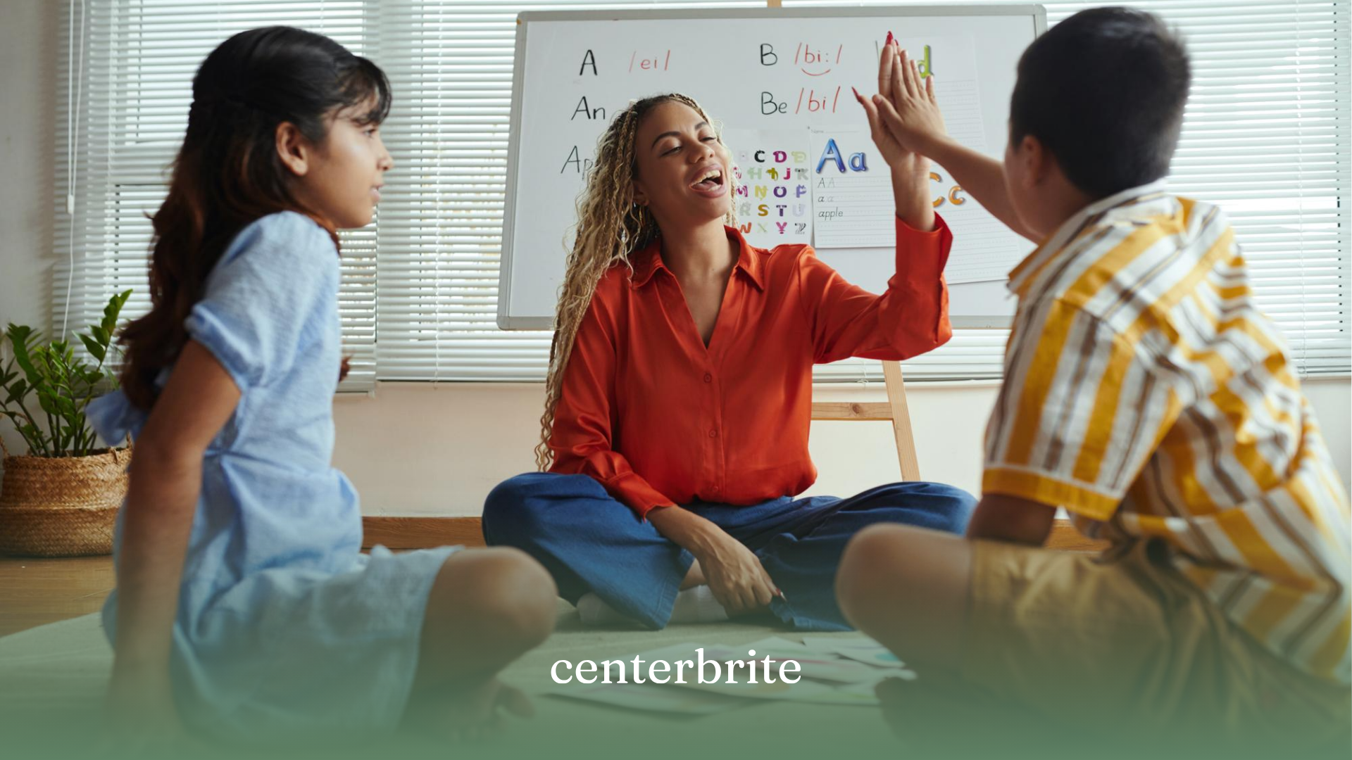 Two kids and an ABA therapist sitting on the floor during ABA therapy