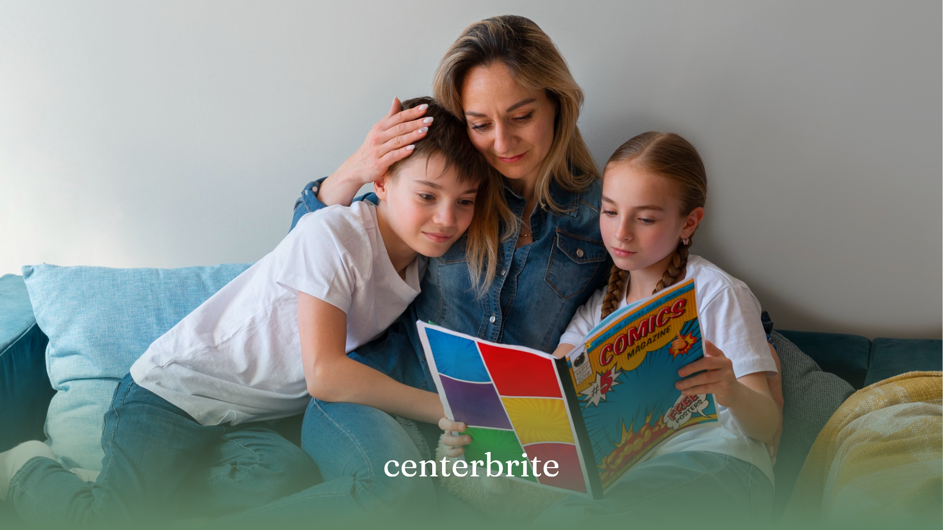 A mother with her kids reading a book on social stories while sitting on a couch
