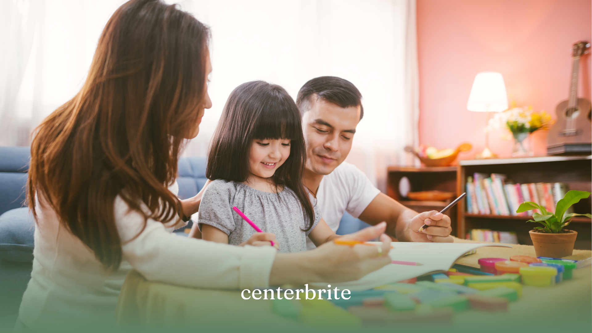 Parents coloring with their daughter during ABA therapy