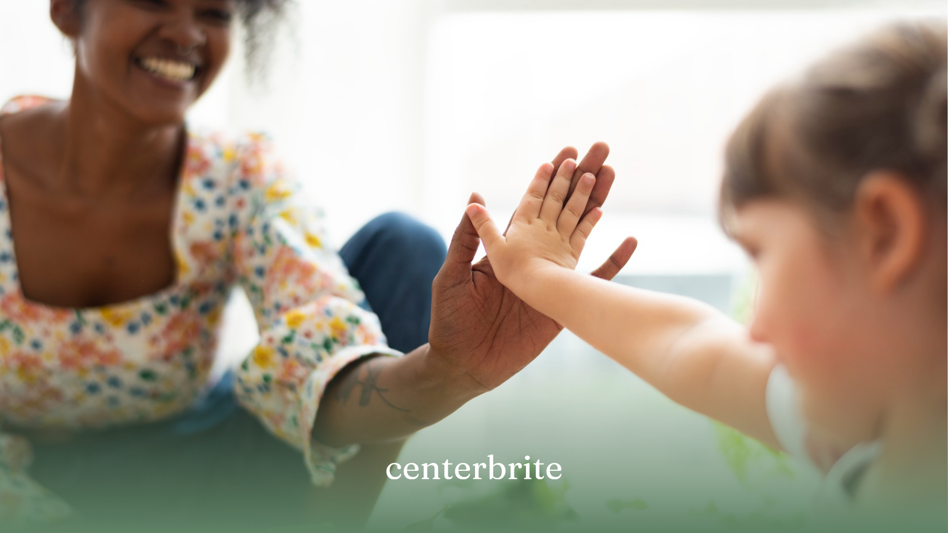A kid with autism high-fiving his ABA therapist