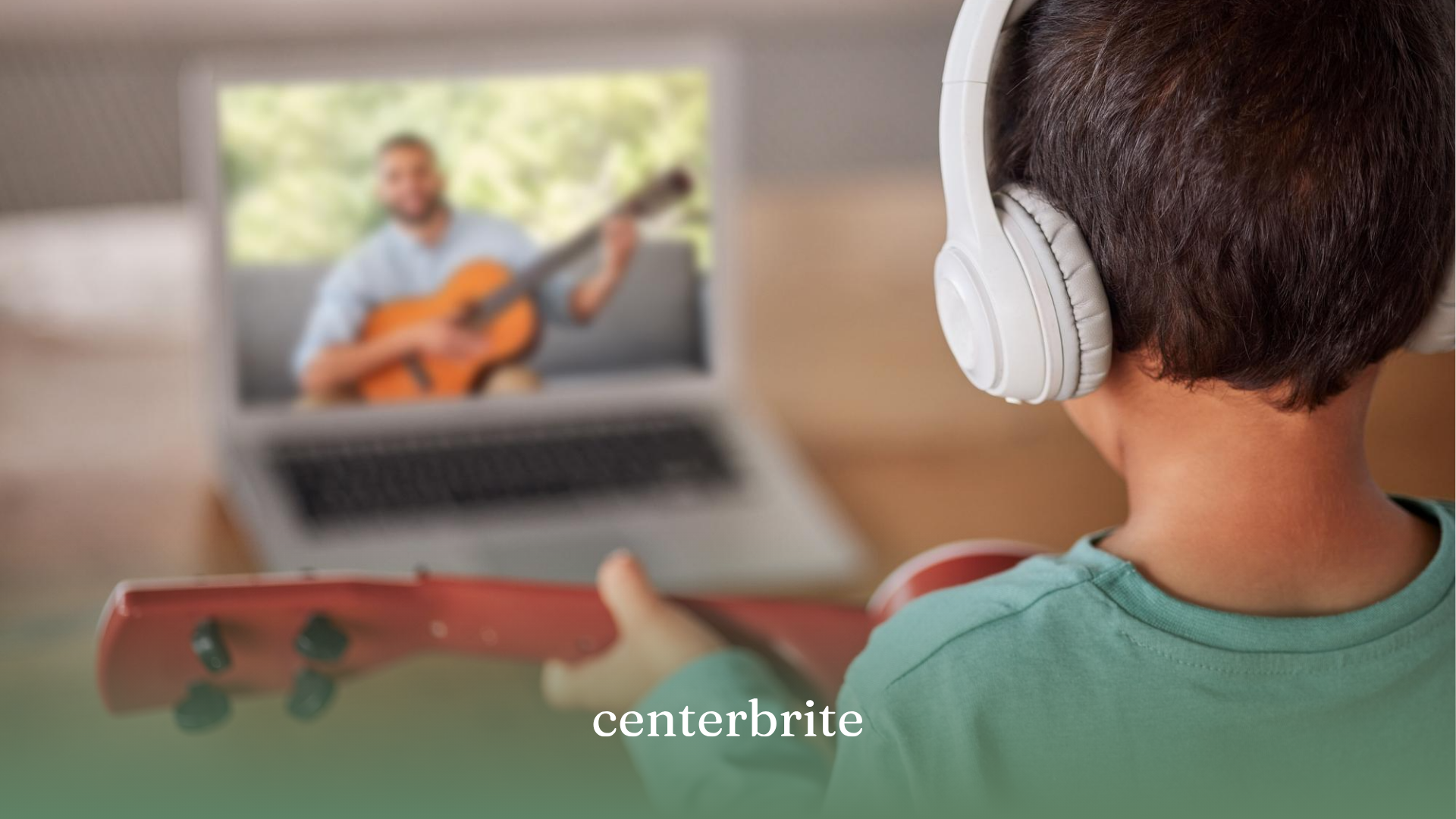 A kid watching a video tutorial on how to play a guitar